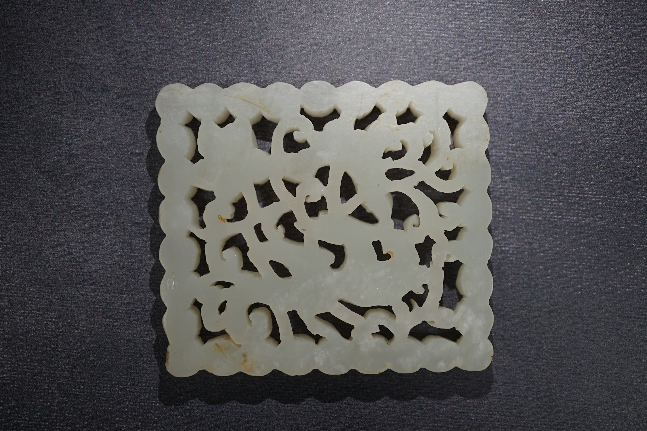 A Chinese pale celadon jade plaque, 17th/18th century, now inset into a hongmu box